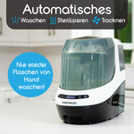 Ein Baby Brezza.de Formula Pro Mini & Bottle Washer Pro steht mit geschlossenem Behälter auf einer Küchentheke. Auf einem Etikett steht „Automatisches Waschen, Sterilisieren, Trocknen“, auf einem anderen steht „Nie wieder Flaschen von Hand waschen!“ und hebt damit seine routinevereinfachenden Fähigkeiten hervor. - product thumbnail