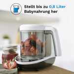 Auf einer Holzoberfläche ist der Baby Brezza Food Maker Deluxe: Babynahrungszubereiter von Baby Brezza.de teilweise mit geschnittenen Erdbeeren gefüllt. Daneben stehen ein Fruchtpüree-Glas und ein Tuch. Der deutsche Text hebt die 3-in-1-Funktionalität für die Zubereitung von bis zu 0,8 Litern Babynahrung und das spülmaschinenfeste Design hervor. - product thumbnail